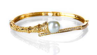 Beautiful golden bracelet with pearl on isolated on white clipart