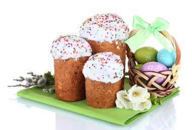 Beautiful Easter cakes, colorful eggs in basket and flowers isolated on white clipart