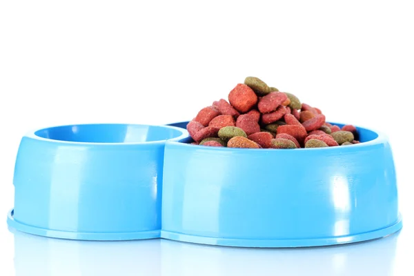 Dry dog food and water in blue bowl isolated on white — Stock Photo, Image