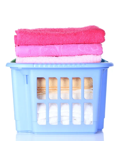 Plastic basket with bright towels isolated on white — Stock Photo, Image