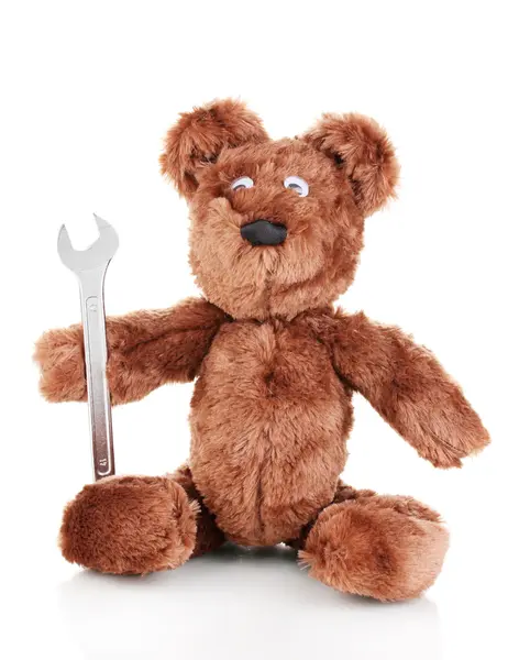 Sitting bear toy with wrench isolated on white — Stock Photo, Image