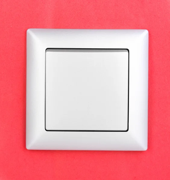 Kırmızı zemin üzerine modern ışık anahtarı — Stok fotoğraf