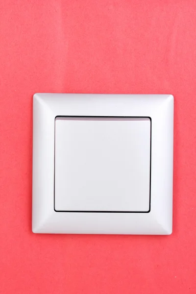 Современный выключатель света на красном фоне — стоковое фото