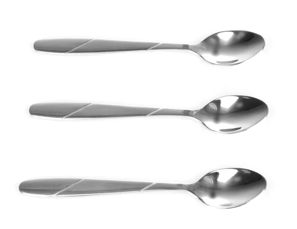 Tre cucchiai d'argento isolati su bianco — Foto Stock