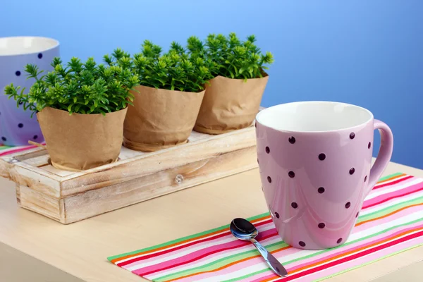 stock image Coffee cup on table in cafe on blue background