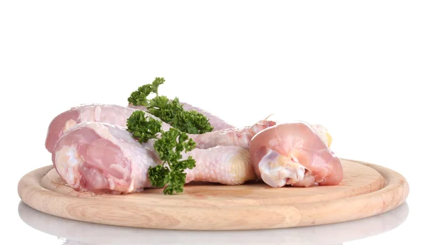 Raw Chicken Drumsticks with parsley on cutting board isolated on white — Stock Photo, Image
