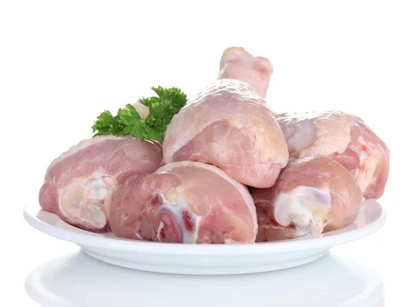 Palitos de pollo crudos en plato con perejil aislado en blanco —  Fotos de Stock
