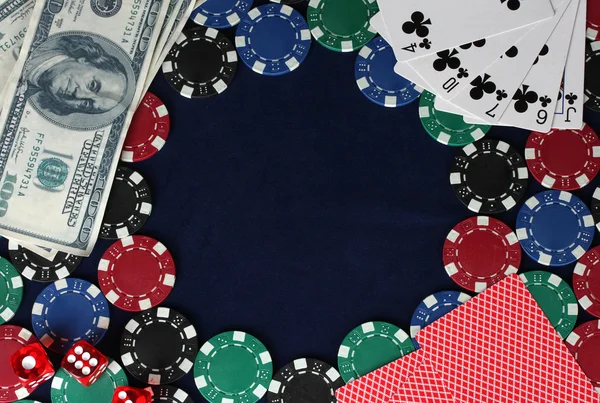 Frame made of poker chips, playing cards and dollars on the blue background — Stock Photo, Image