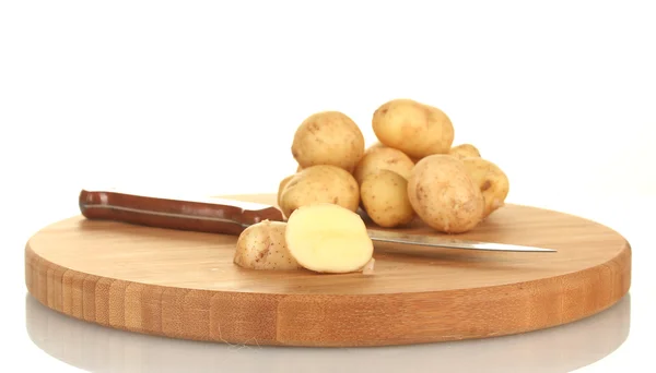 Patatas jóvenes en una tabla de cortar con cuchillo aislado en blanco — Foto de Stock