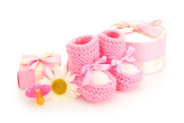 Botas de bebê rosa, chupeta, presentes e flores isoladas em branco — Fotografia de Stock
