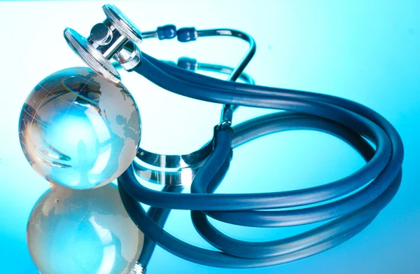 stock image Globe and stethoscope on blue