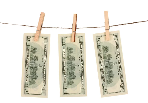 stock image Three one hundred dollar bills is hanging on a rope with wooden clothespin isolated on white