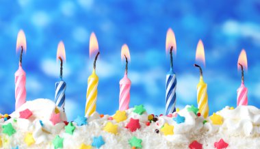 Beautiful birthday candles on blue background clipart