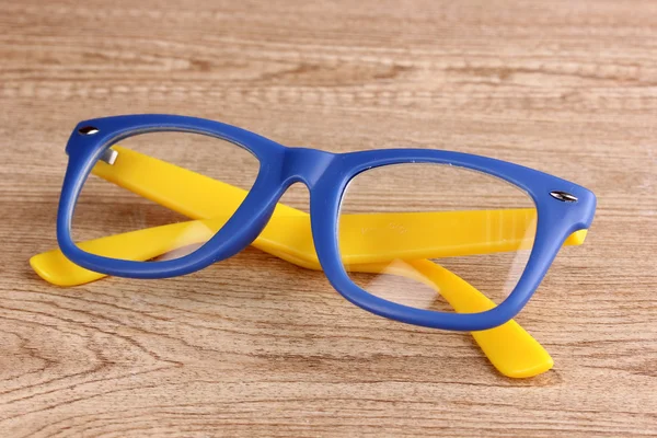 Vacker färg glasögon på trä bakgrund — Stockfoto