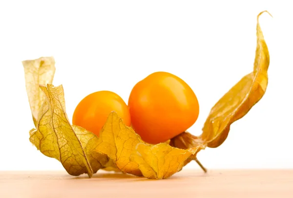 Physalis on wooden table on white background — Stock Photo, Image