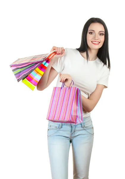 Beautiful young girl holding bright bags isolated on white — Stock Photo, Image