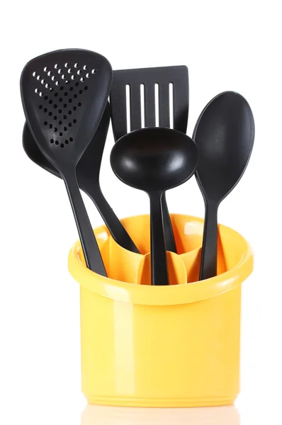 Black kitchen utensils in yellow stand isolated on white — Stock Photo, Image