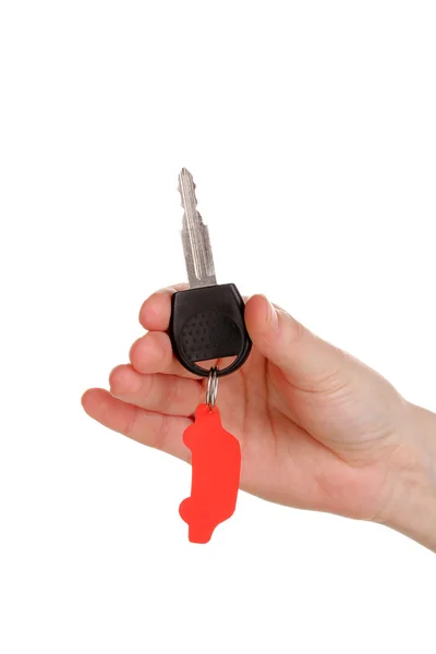 Klíč od auta s šarmem v ruce izolovaných na bílém — Stock fotografie