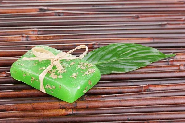 Hand-made herbal soap on bamboo mat — Stock Photo, Image