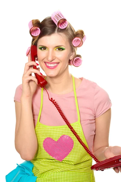 Schöne junge Hausfrau mit rotem Telefon isoliert auf weißem — Stockfoto