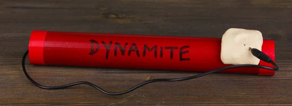 Dynamite on wooden table on grey background — Stock Photo, Image