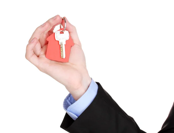 Key with house-shaped charm in hand isolated on white — Stock Photo, Image
