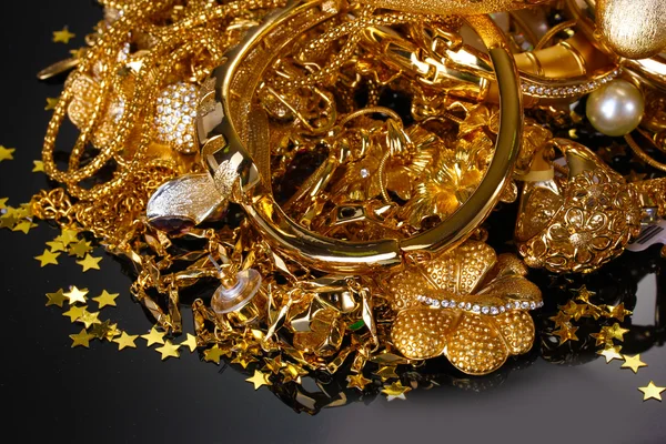 Beautiful golden jewelry on grey background — Stock Photo, Image