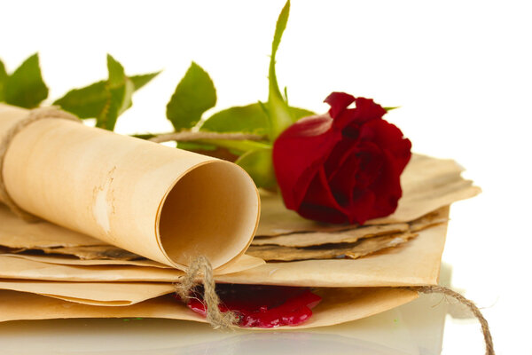 The old parchments and letters with a rose on a white background close-up