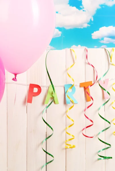Party. Balloons against a wooden fence on sky background — Stock Photo, Image