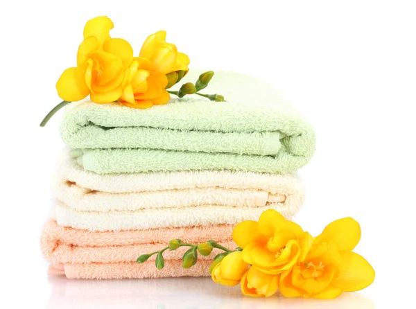 Colorful towels and flowers isolated on white Stock Image