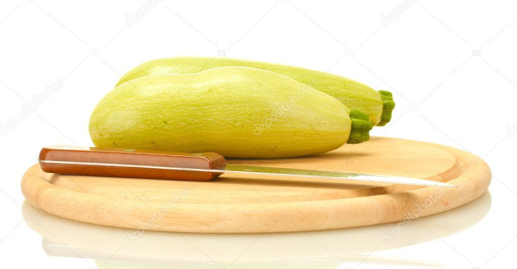 Squash on a cutting board with knife isolated on white background