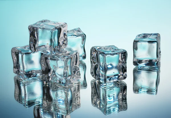 Ice cubes on blue background — Stock Photo, Image
