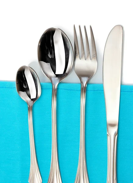 Fork, spoon and knife on a blue tablecloth — Stock Photo, Image