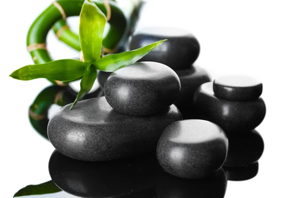 Spa stones and green bamboo on grey background — Stock Photo, Image