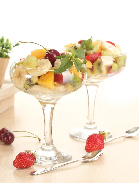 Frisk fruktsalat og jordbær på trebord – stockfoto