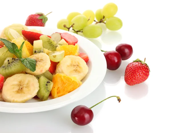Fresh fruits salad on plate and berries isolated on white — Stock Photo, Image