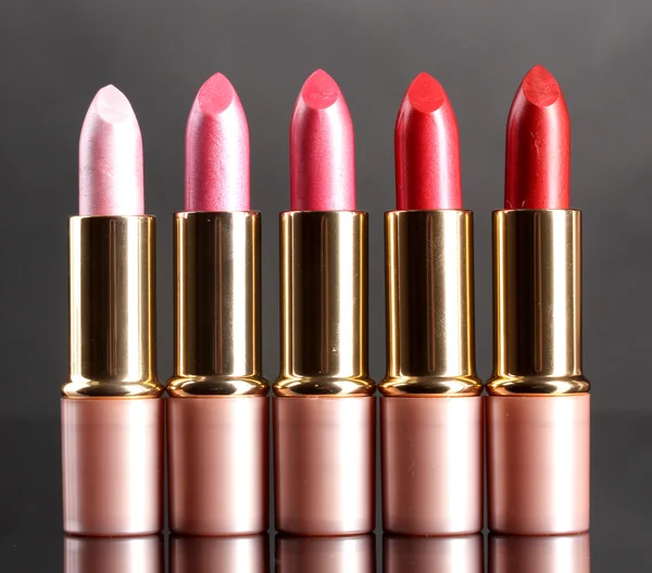 Beautiful lipsticks on gray background — Stock Photo, Image