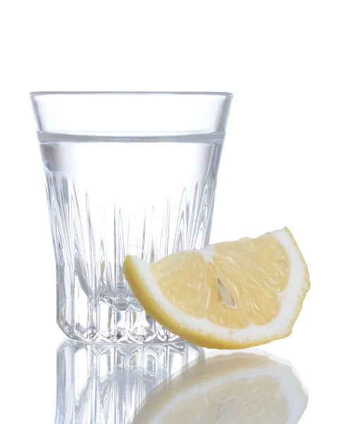 Glass of vodka with lemon isolated on white — Stock Photo, Image