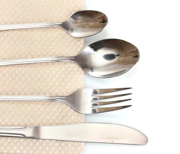 Fork, spoon and knife on a beige tablecloth — Stock Photo, Image
