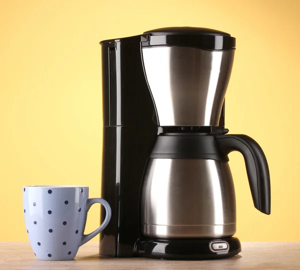 Coffee maker on yellow background — Stock Photo, Image