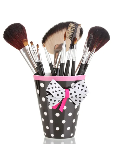 Makeup brushes in a black polka-dot cup isolated on white — Stock Photo, Image