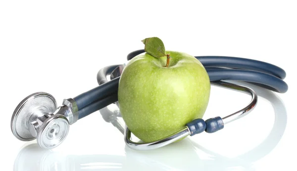 Medicinsk stetoskop och grönt äpple isolerad på vit Stockfoto