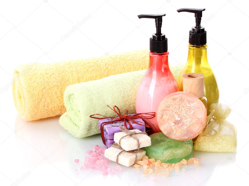 Bottles, soaps, sea salt and towels isolated on white