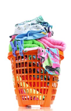 Clothes in orange plastic basket isolated on white clipart