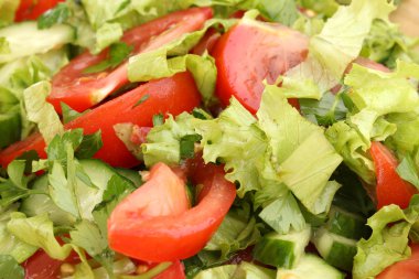 Fresh salad with tomatoes and cucumbers close-up clipart