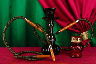 Hookah on a wooden table on a background of curtain close-up clipart