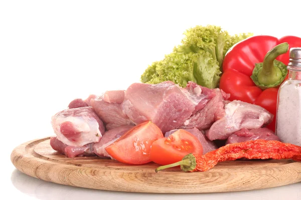 Trozos de carne cruda y verduras en tableros de madera aislados en blanco — Foto de Stock