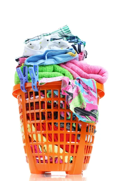 Clothes in orange plastic basket isolated on white — Stock Photo, Image