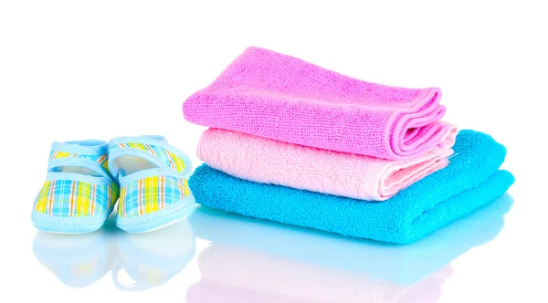 Blue baby booties and three colorful towels isolated on white — Stock Photo, Image