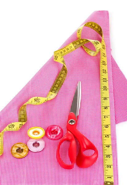 Scissors, buttons, measuring tape and pattern on fabric isolated on white — Stock Photo, Image